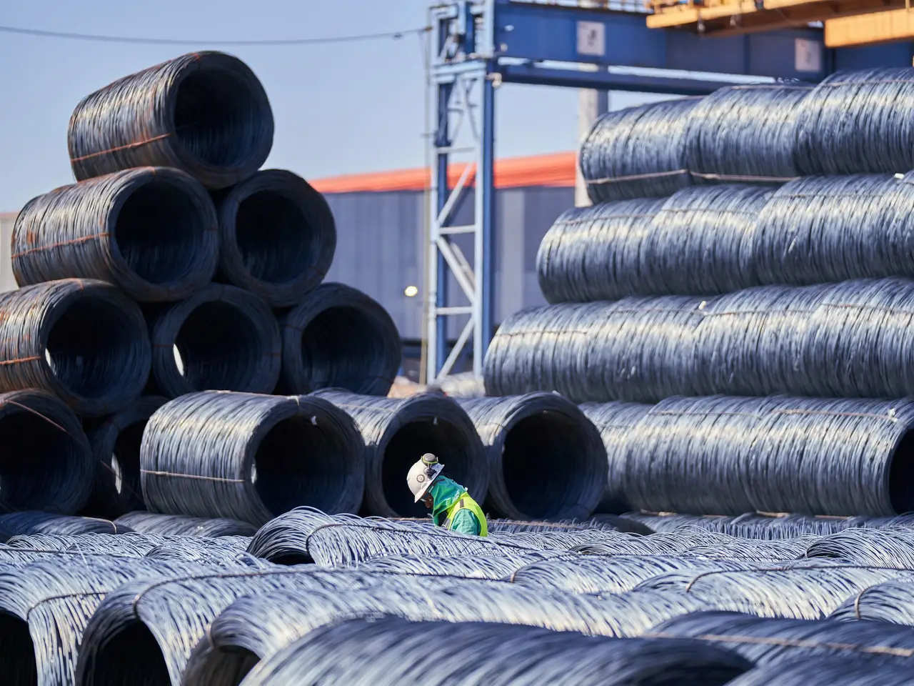 Stacked wire coils beside a mill gantry