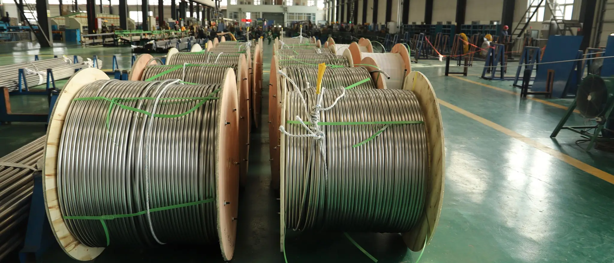 Coils of drawn wire on reels inside a wire mill